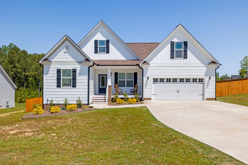 Residential concrete driveway with defined joints and garage approach
